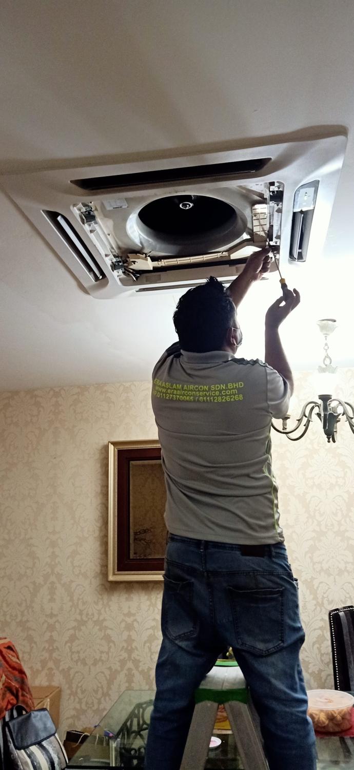 Technician servicing a ceiling cassette