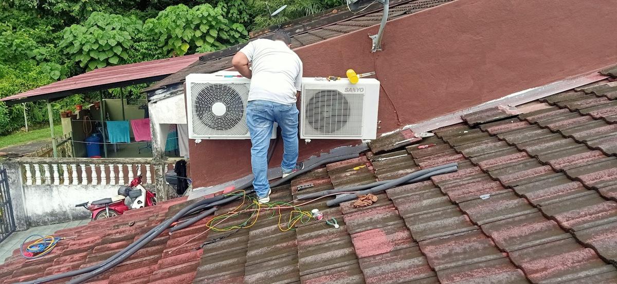 Technician installing outdoor units on a roof